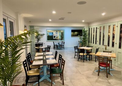 Elegant dining area at Best Western Adelaide Airport Motel with modern decor, wooden tables, and comfortable seating.